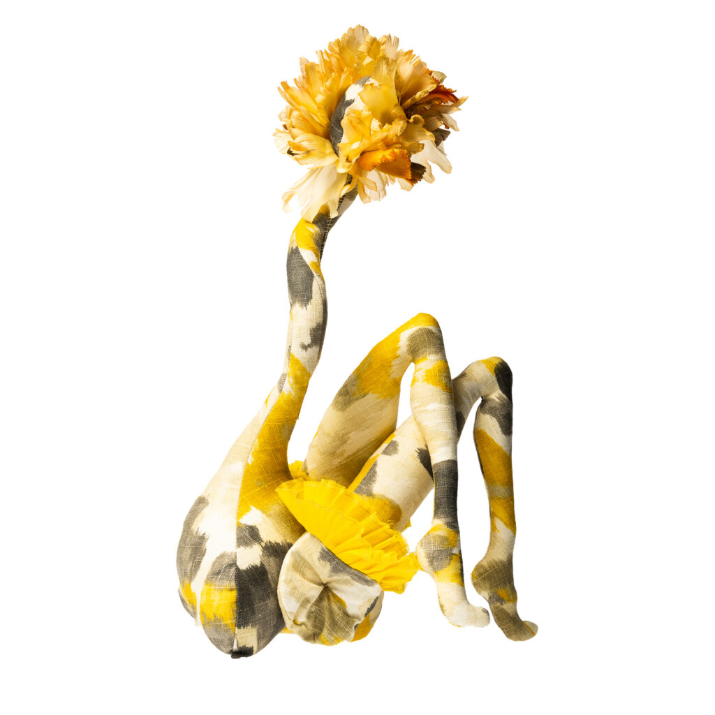 yellow amorphous figure with floral and humanoid forms